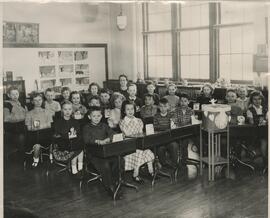 The Third Grade teacher Mrs. Batton, children sitting at desks