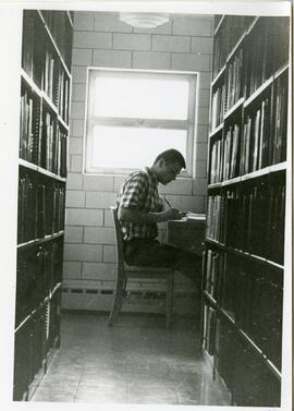 Man studying in library, 1968.