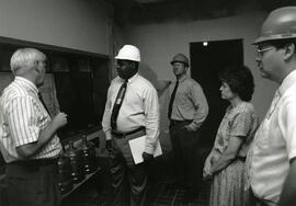 Staff reviewing progress of remodeling, circa 1995.