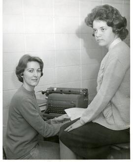 Meletean Editors seated with a typewriter, 1964.