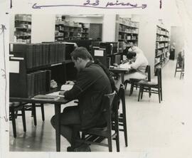 Students studying in the library carrels, no date.