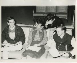 Group of students reading on a couch, no date.