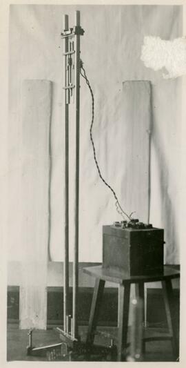 Large piece of physics equipment with part on a stool