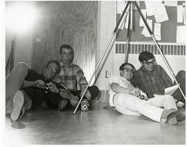 Students on the ground with cameras, 1968.