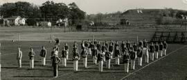 band standing in field in uniform