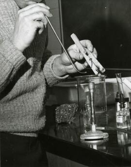 Student using tools and beaker