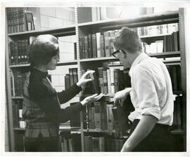 Woman by shelved papers, 1968.