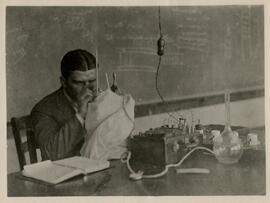 Person looking at equipment with notebook