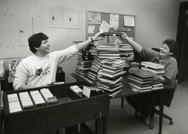 Library staff in the circulation area of the library, 1987.