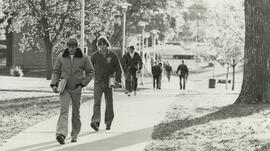 walking across campus with books