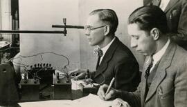 Student looking into piece of equipment