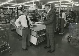 Howard Larsen presenting check from Guikson Supermarket to Orland Born, 1977.