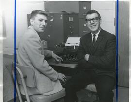 Men Sitting at Desk with Typwriter