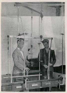Student and professor using tall equipment