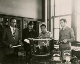 Group sitting behind lab equipment