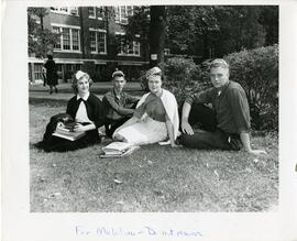 Students sitting on the grass wearing freshman beanies, 1950