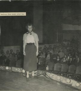 Genevieve Olson standing in front of audience, no date.