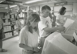 Students printing book list for textbooks, circa 1990's.