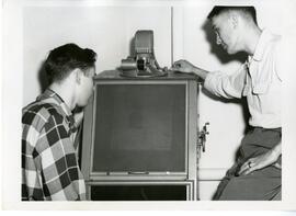 Students viewing the Microfilm reader in the Library.