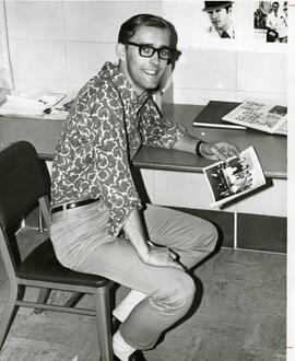 Larry J. seated at a desk, 1968,