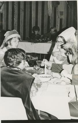 Group of people eating at Madrigal Banquet.