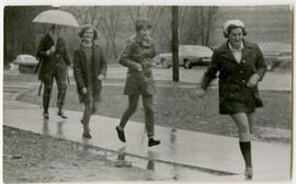 Students walking in the rain.