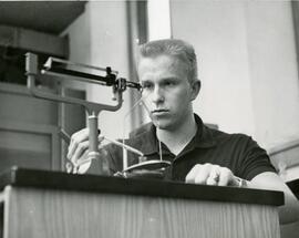 Student using scale and pipette