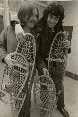 People holding snowshoes.