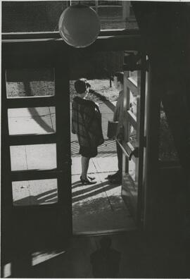 Two people standing outside building, 1968.