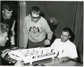 Students playing a game in off campus housing, 1968.