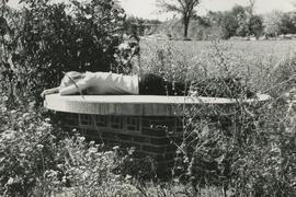 Student laying facedown on stone table, 1975.