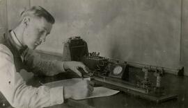 Person taking notes in front of equipment