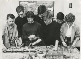 Older students conducting an experiment with a model train