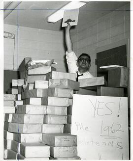 Student holding up Meletean book, 1962.