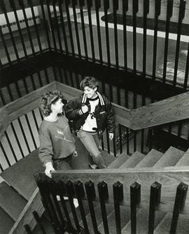 Students walking up the stairs in the library, 1987.