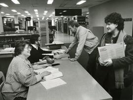 Students at the library reference desk, 1987.