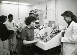 Group looking at beakers in lab equipment
