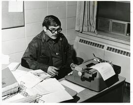 Student seated at a desk with a typewriter, 1968.