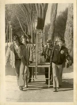 Students carrying large test tube rack