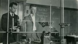 Two students using physics equipment