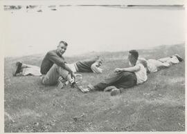 Students lounging on the grass.