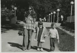 woman walking with two kids