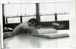 Student sleeping on books.