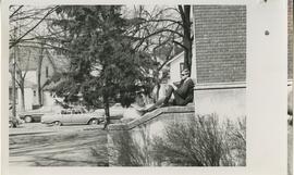 Person sitting on ledge next to stairs, 1968.