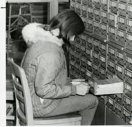 Woman referencing library card catalog, 1969.