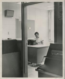 View of a person using a typewriter, no date.