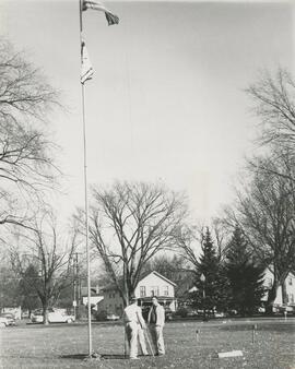 talking beneath flagpole