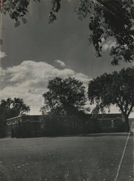 Industrial arts building through trees