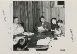 Students seated around a table.