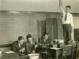 Group experimenting with one student on chair